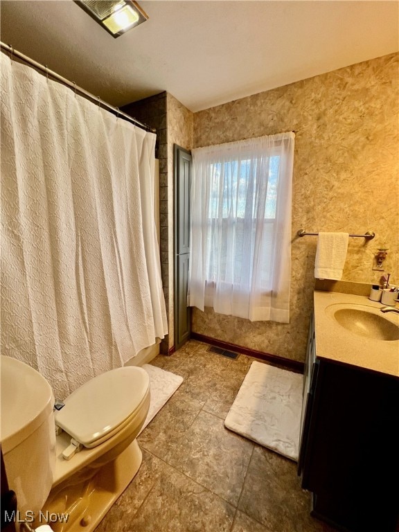 bathroom with tile patterned floors, vanity, and toilet