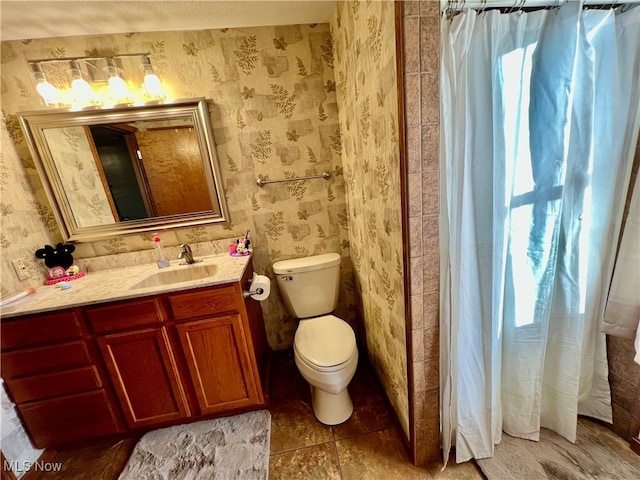 bathroom featuring tile patterned flooring, vanity, and toilet