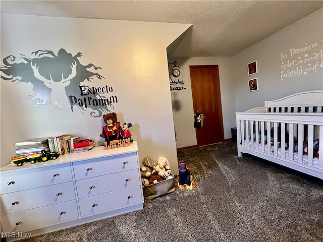 carpeted bedroom featuring a crib and a textured ceiling