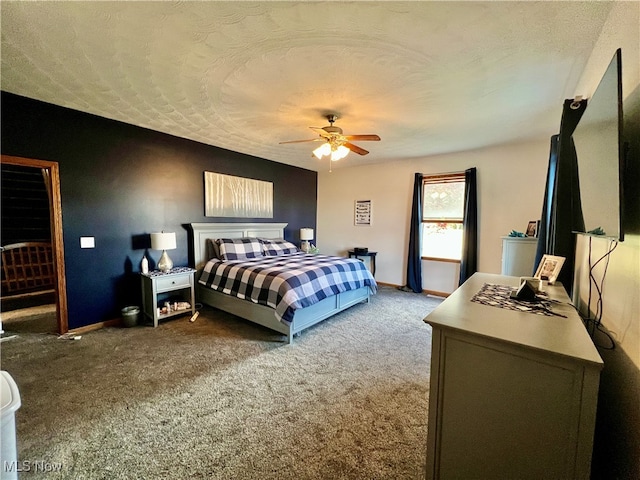 bedroom featuring ceiling fan, carpet floors, and a textured ceiling