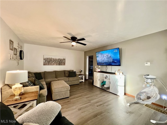 living room with ceiling fan and wood-type flooring