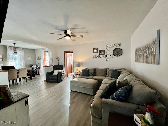 living room with ceiling fan and wood-type flooring