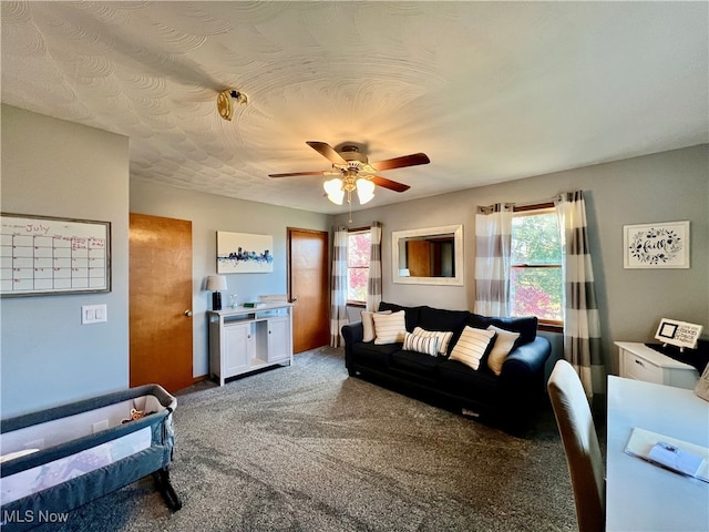 living room with ceiling fan and carpet floors