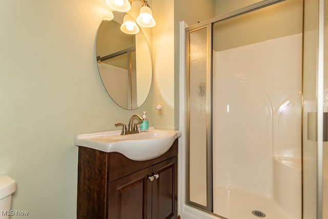 bathroom with vanity and a shower with shower door