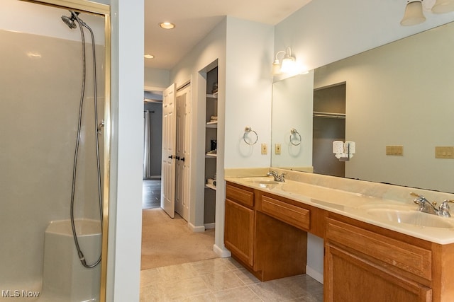 bathroom with vanity, tile patterned floors, and walk in shower