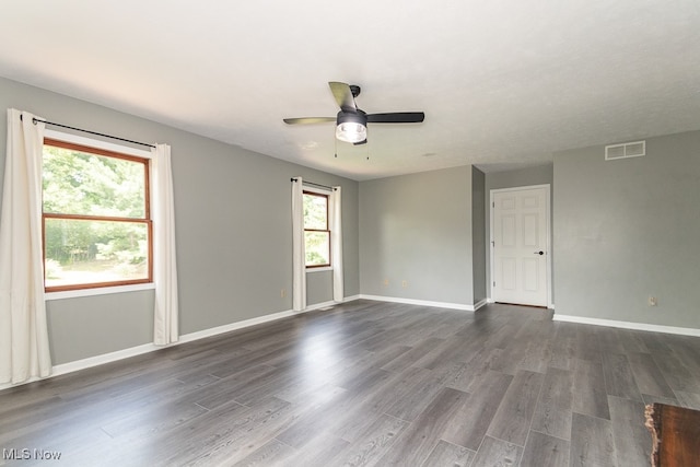 empty room featuring ceiling fan and dark wood-type flooring