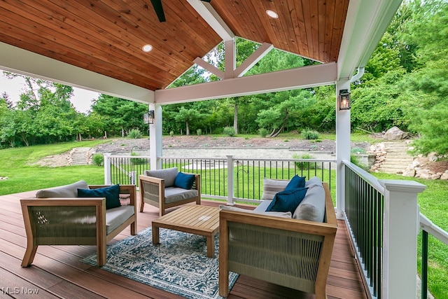 deck with outdoor lounge area and a yard