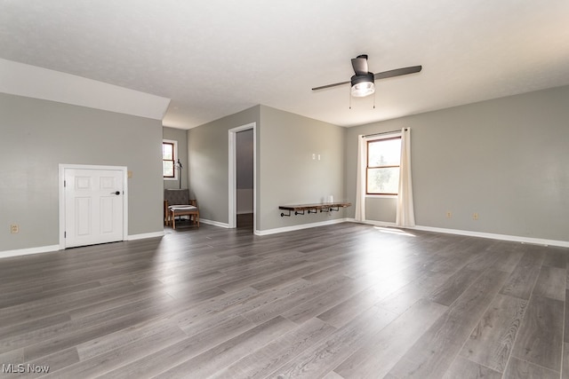 empty room featuring ceiling fan and dark wood-type flooring