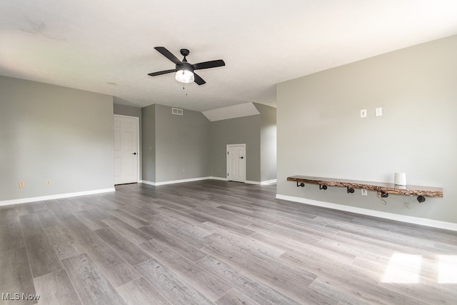 unfurnished living room featuring hardwood / wood-style floors, ceiling fan, and lofted ceiling