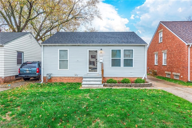 bungalow-style home featuring a front yard