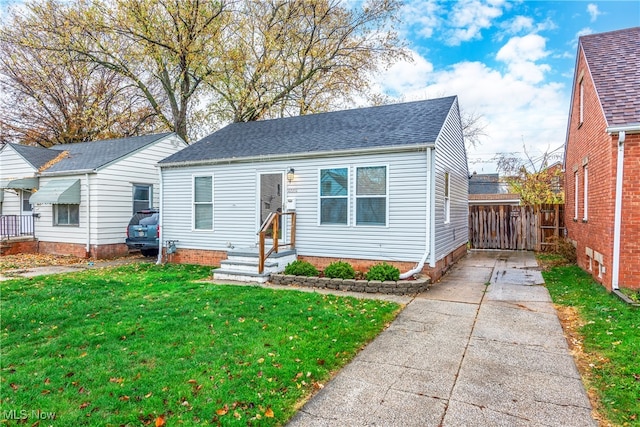 bungalow-style house with a front lawn