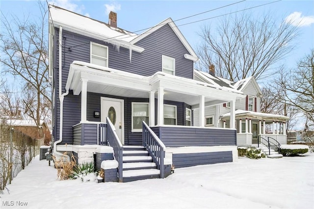 view of front of property with a porch and cooling unit