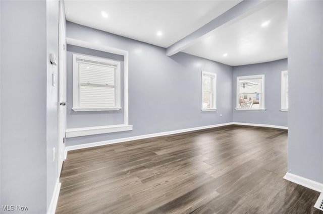 unfurnished room featuring recessed lighting, baseboards, dark wood-style flooring, and beamed ceiling