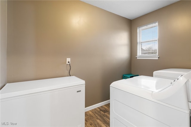 washroom featuring washing machine and dryer and dark hardwood / wood-style floors