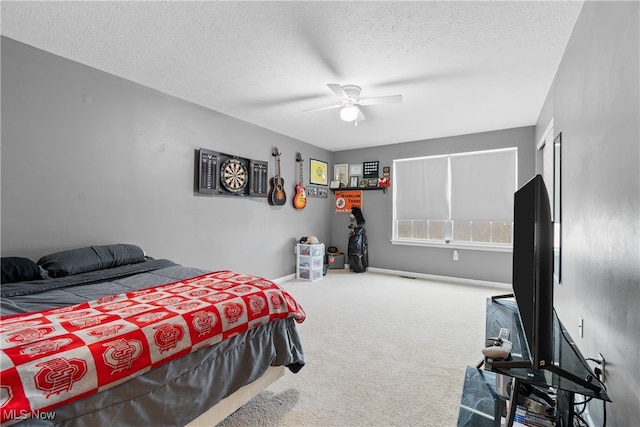 carpeted bedroom with ceiling fan and a textured ceiling