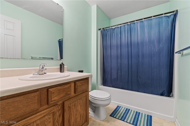 full bathroom featuring shower / bath combo, tile patterned floors, a textured ceiling, toilet, and vanity