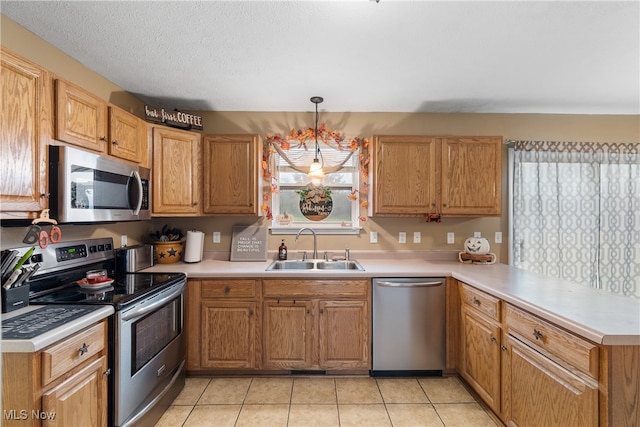 kitchen featuring sink, stainless steel appliances, a notable chandelier, decorative light fixtures, and light tile patterned floors