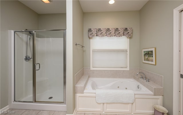 bathroom with tile patterned floors and shower with separate bathtub