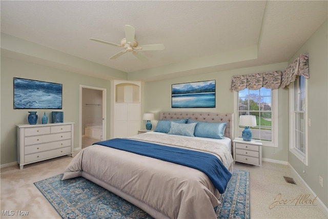 carpeted bedroom featuring ceiling fan, a textured ceiling, and connected bathroom