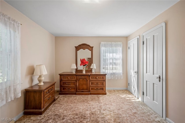 bedroom featuring light carpet