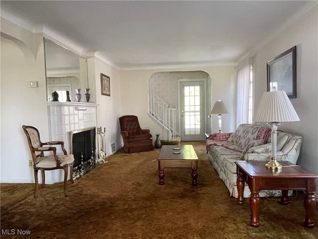 carpeted living room with a fireplace and ornamental molding