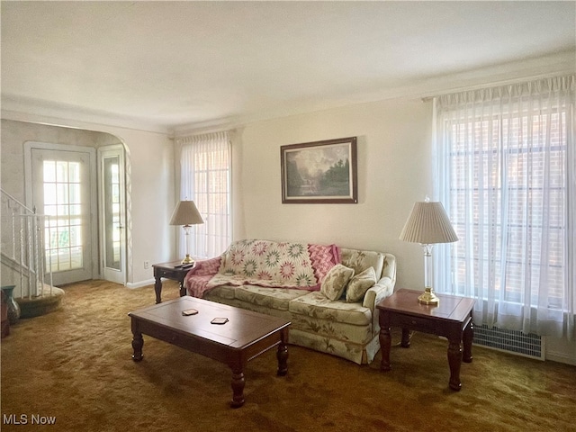 carpeted living room with ornamental molding