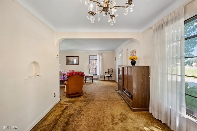 hallway with carpet flooring, a wealth of natural light, and ornamental molding