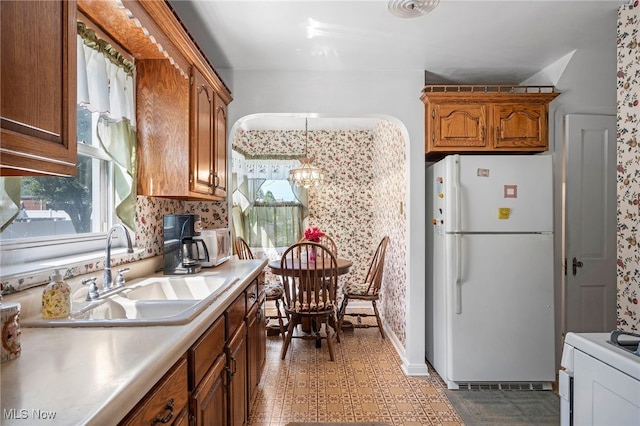 kitchen with white appliances and sink