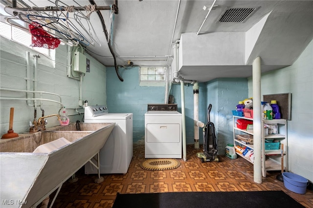 laundry room with washing machine and dryer and electric panel