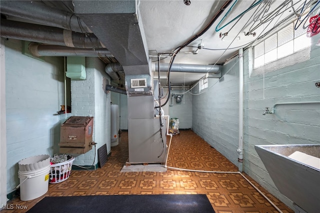 basement featuring heating unit and water heater