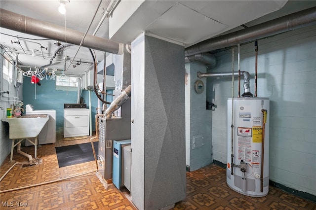 basement with sink, washing machine and dryer, and water heater