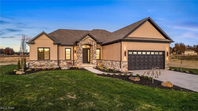 6120 Century Blvd, Canfield, OH 44406 - view of front of home with stone siding, a garage, a front lawn, driveway, and a shingled roof