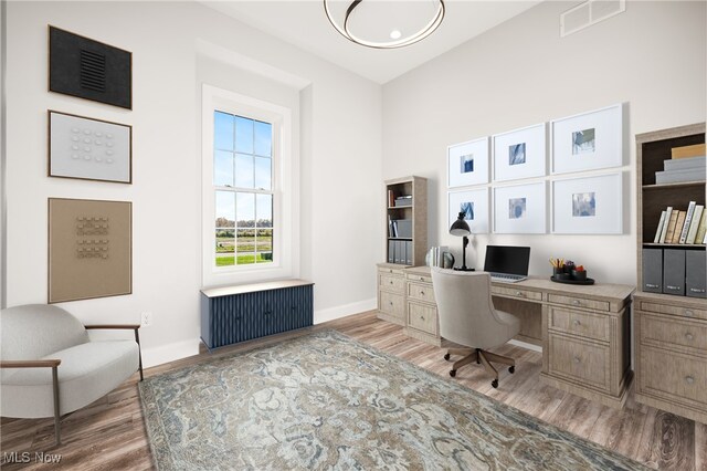 6120 Century Blvd, Canfield, OH 44406 - home office with radiator heating unit, light wood-style flooring, and baseboards