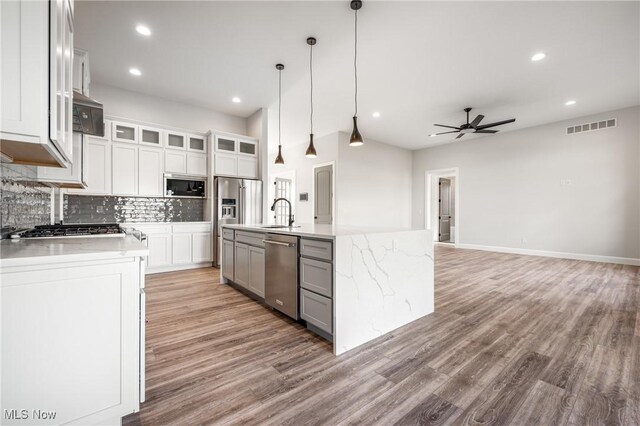 6120 Century Blvd, Canfield, OH 44406 - kitchen featuring appliances with stainless steel finishes, a ceiling fan, light wood-style flooring, tasteful backsplash, and gray cabinetry
