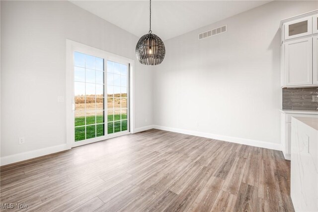 6120 Century Blvd, Canfield, OH 44406 - unfurnished dining area featuring healthy amount of natural light, light wood-style floors, and baseboards