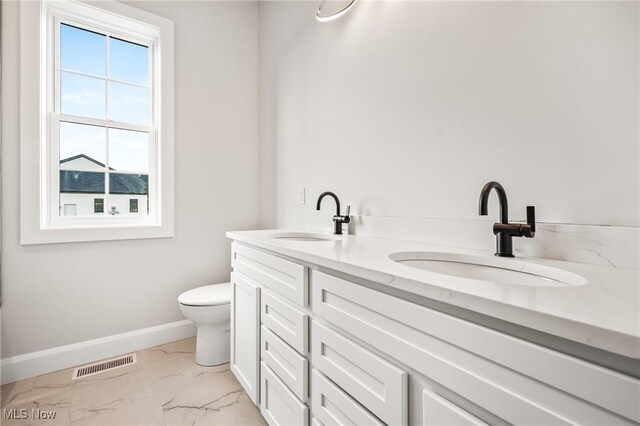 6120 Century Blvd, Canfield, OH 44406 - full bath featuring marble look tiles, baseboards, double vanity, and toilet