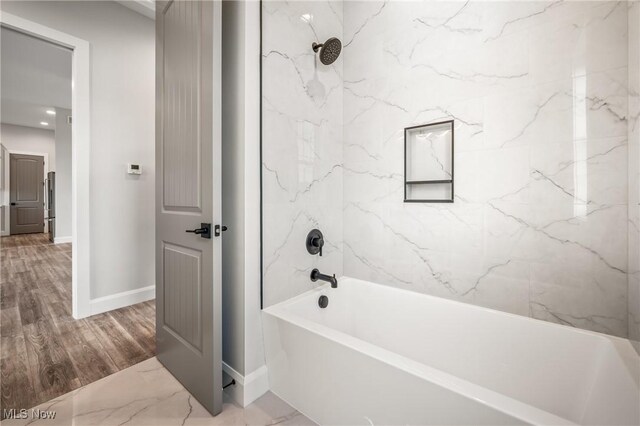 6120 Century Blvd, Canfield, OH 44406 - bathroom featuring washtub / shower combination, baseboards, and wood finished floors