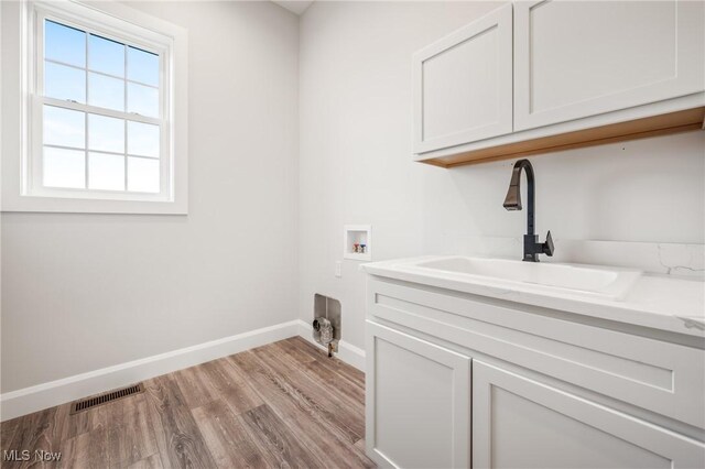 6120 Century Blvd, Canfield, OH 44406 - laundry room featuring washer hookup, cabinet space, baseboards, and light wood-style floors