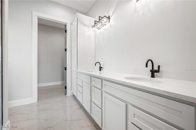 6120 Century Blvd, Canfield, OH 44406 - bathroom with marble look tiles, double vanity, and baseboards