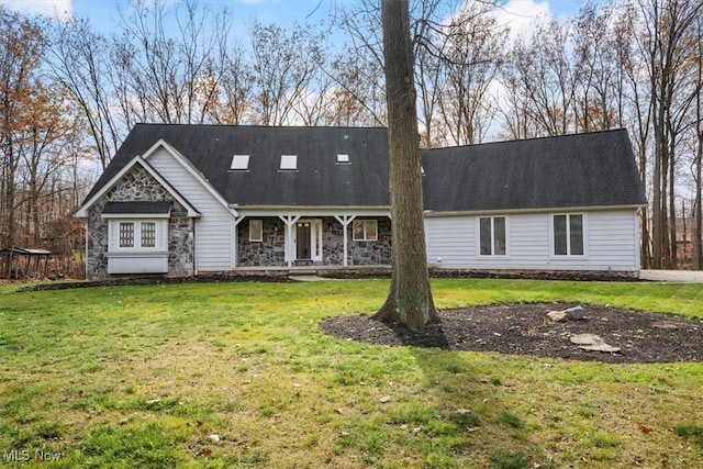 cape cod house featuring a front yard and a porch