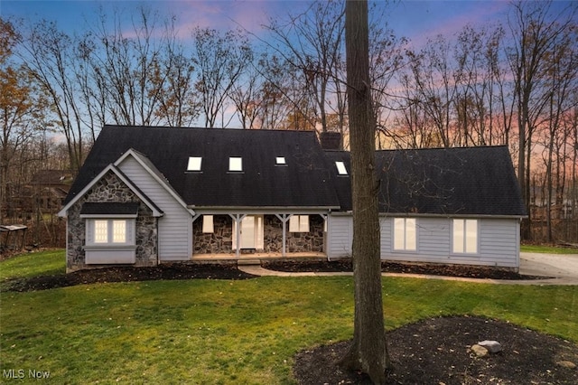 new england style home with a lawn