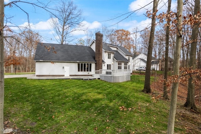 back of house featuring a yard and a deck