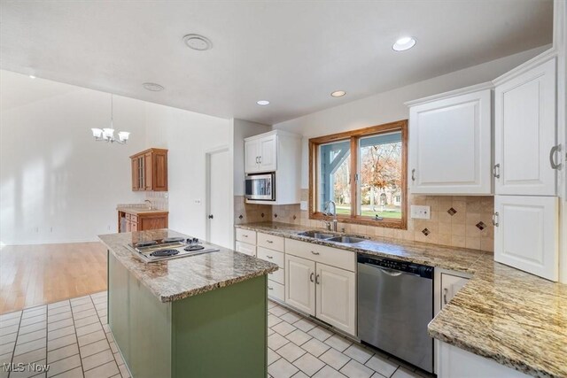 kitchen featuring white cabinetry, sink, a kitchen island, and stainless steel appliances