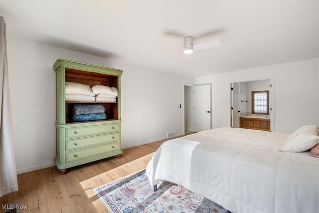 bedroom featuring ceiling fan, light hardwood / wood-style floors, and connected bathroom