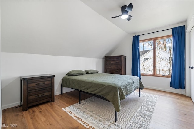 bedroom featuring ceiling fan, lofted ceiling, and light wood-type flooring