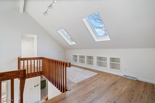 bonus room featuring wood-type flooring and lofted ceiling