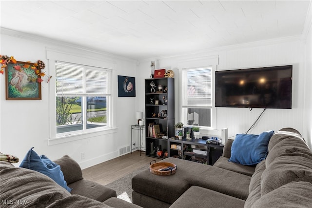 living room with hardwood / wood-style floors and crown molding