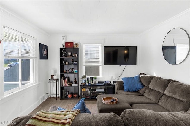 living room featuring wood-type flooring and ornamental molding