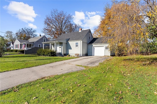 view of front of property with a garage and a front lawn