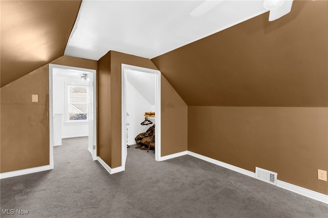 additional living space with carpet, vaulted ceiling, and ceiling fan